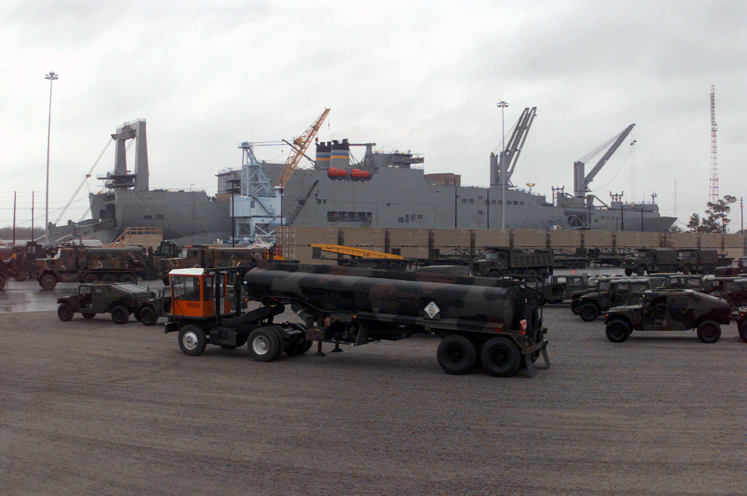 Fuel tanker ship at sea under cloudy sky, representing transoceanic military fuel shipments