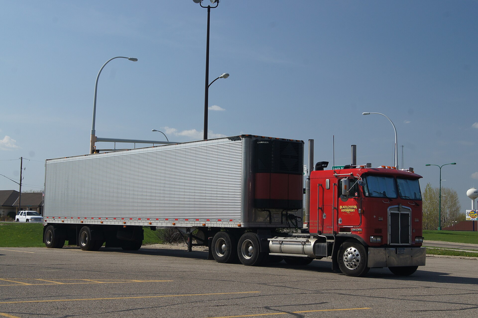 Refrigerated trailer at warehouse dock with temperature monitoring equipment visible