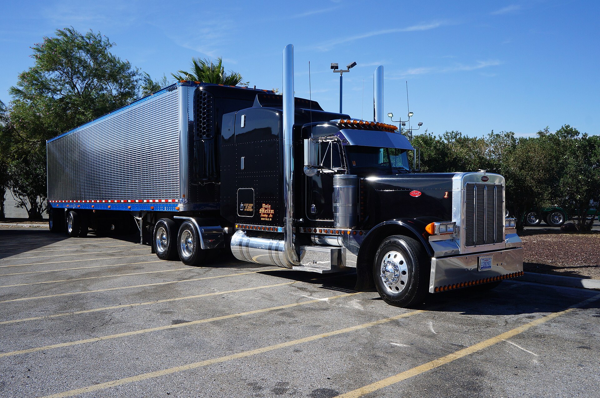 Warehouse worker checking driver credentials at loading dock during freight pickup verification