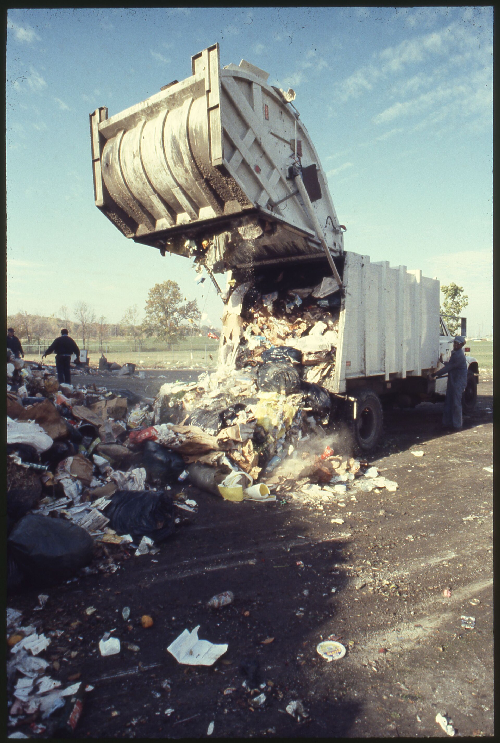 Owner-operator Debon Sims standing beside his truck after building a 3-truck waste-hauling fleet