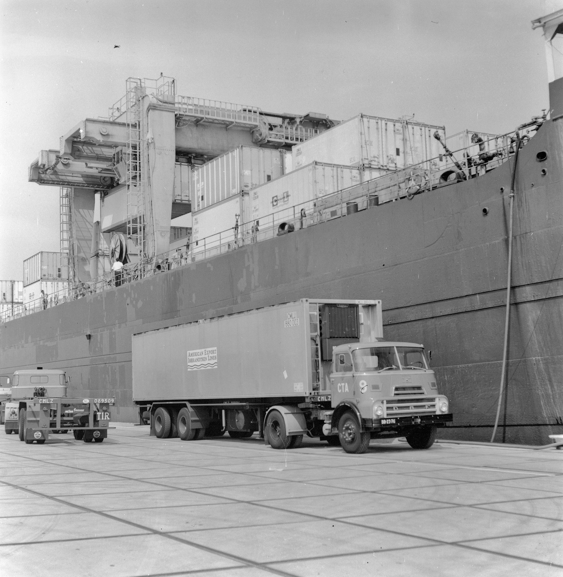 Container terminal at Port of Los Angeles with stacked shipping containers and drayage trucks at gate