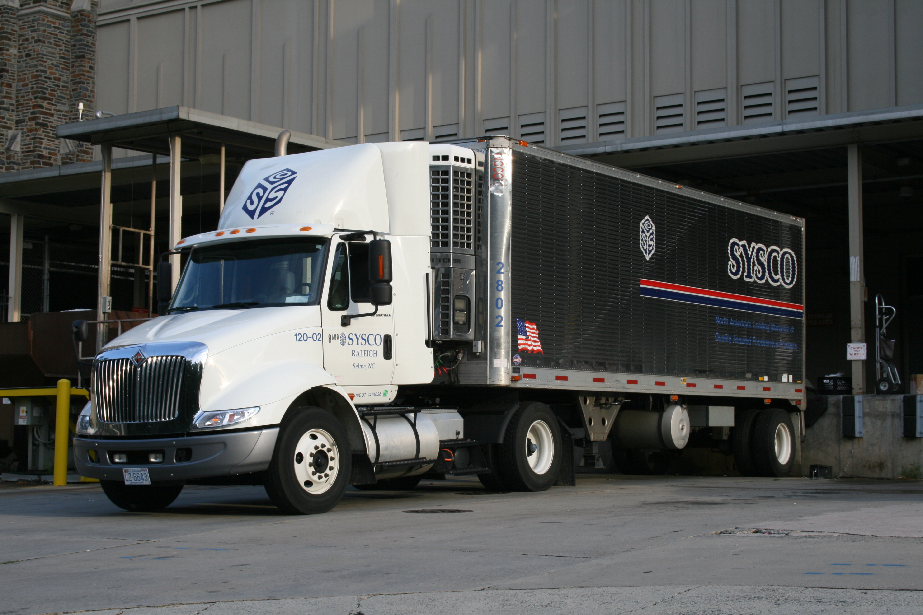 Heavy-duty trucks lined up at a Mexican manufacturing facility awaiting export shipment