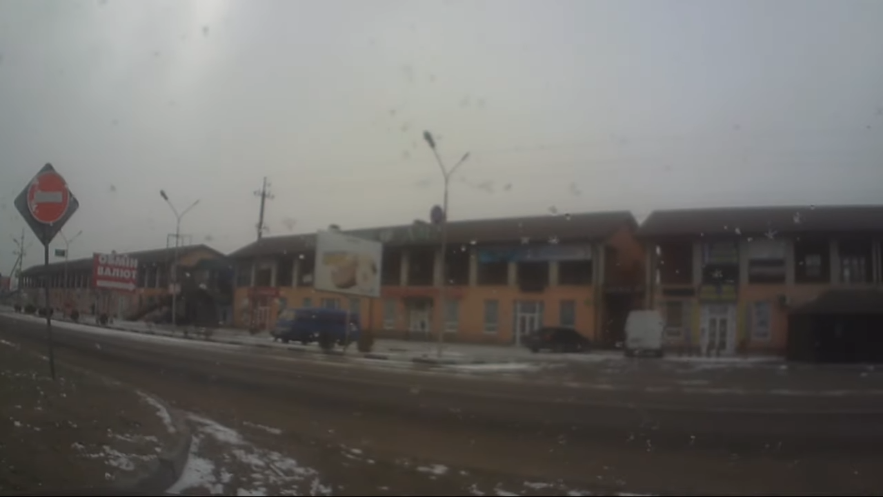 Dual-facing dashcam mounted on truck windshield recording driver and road view