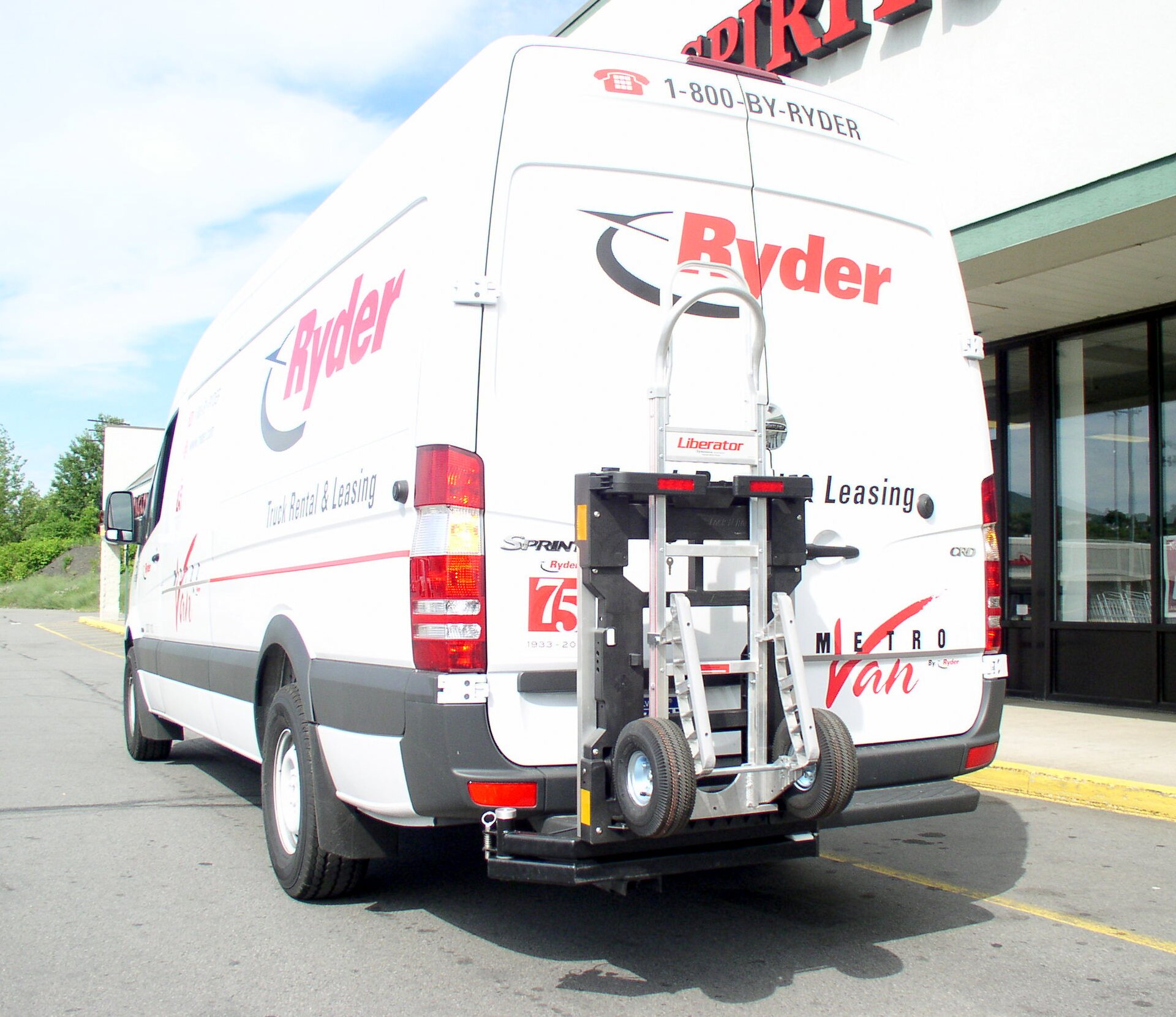 Large LTL carrier terminal with multiple dock doors and trailers backed into loading bays
