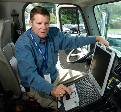 Semi truck parked at a closed trucking terminal with bankruptcy notice on the door