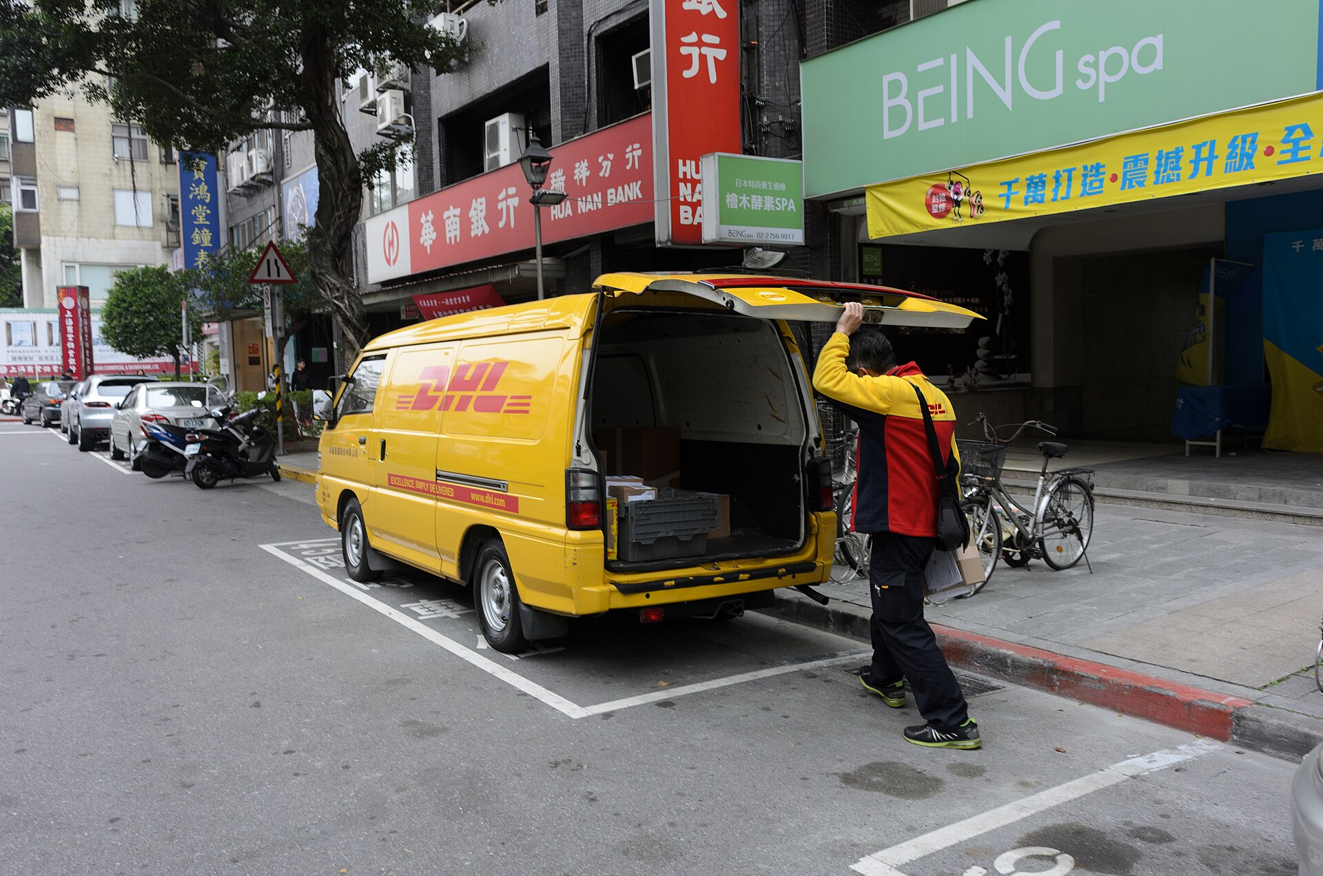 DHL Express delivery truck parked at warehouse loading dock