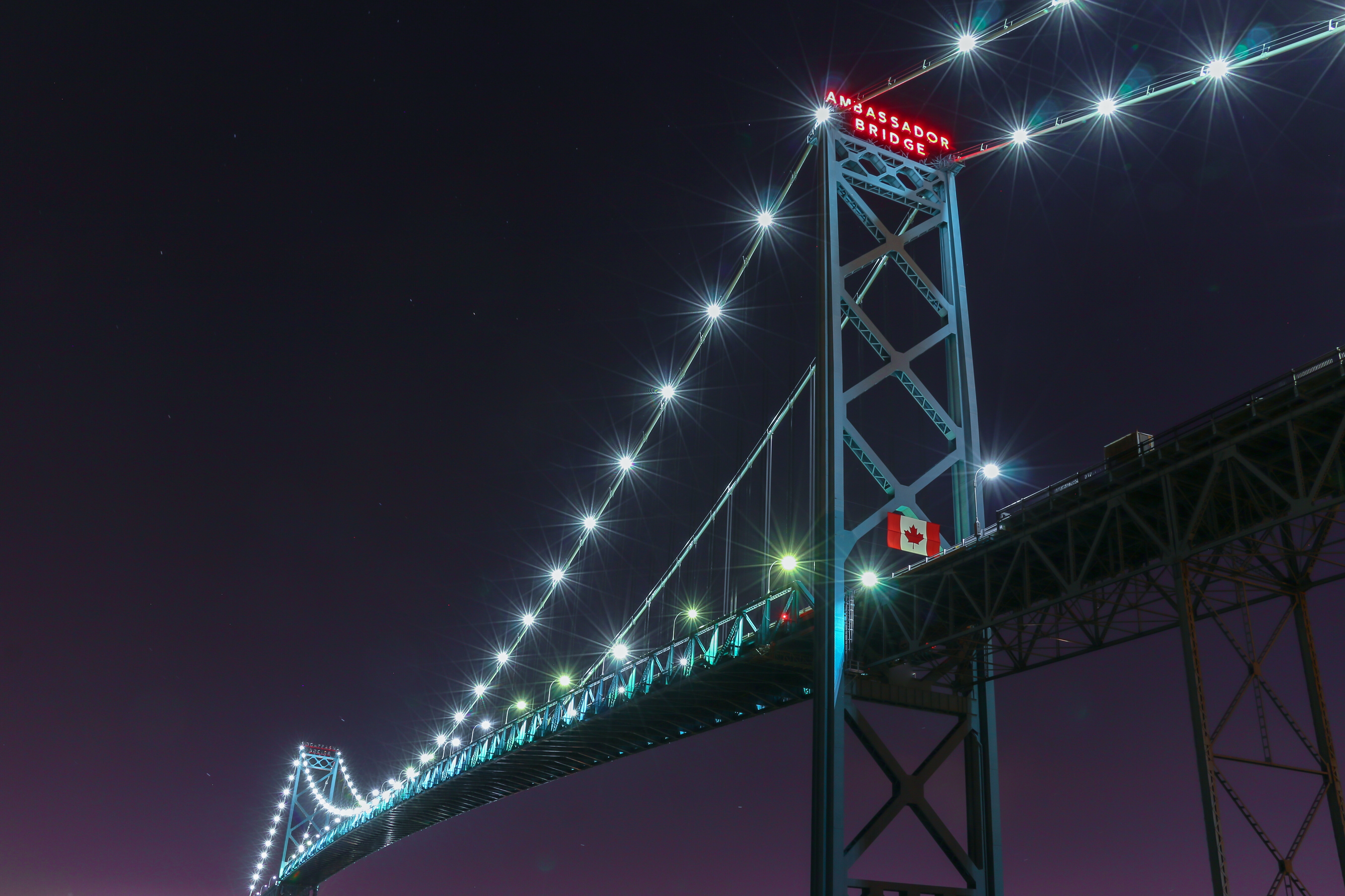 Commercial trucks lined up at a U.S.-Canada border crossing, waiting to clear customs with freight shipments