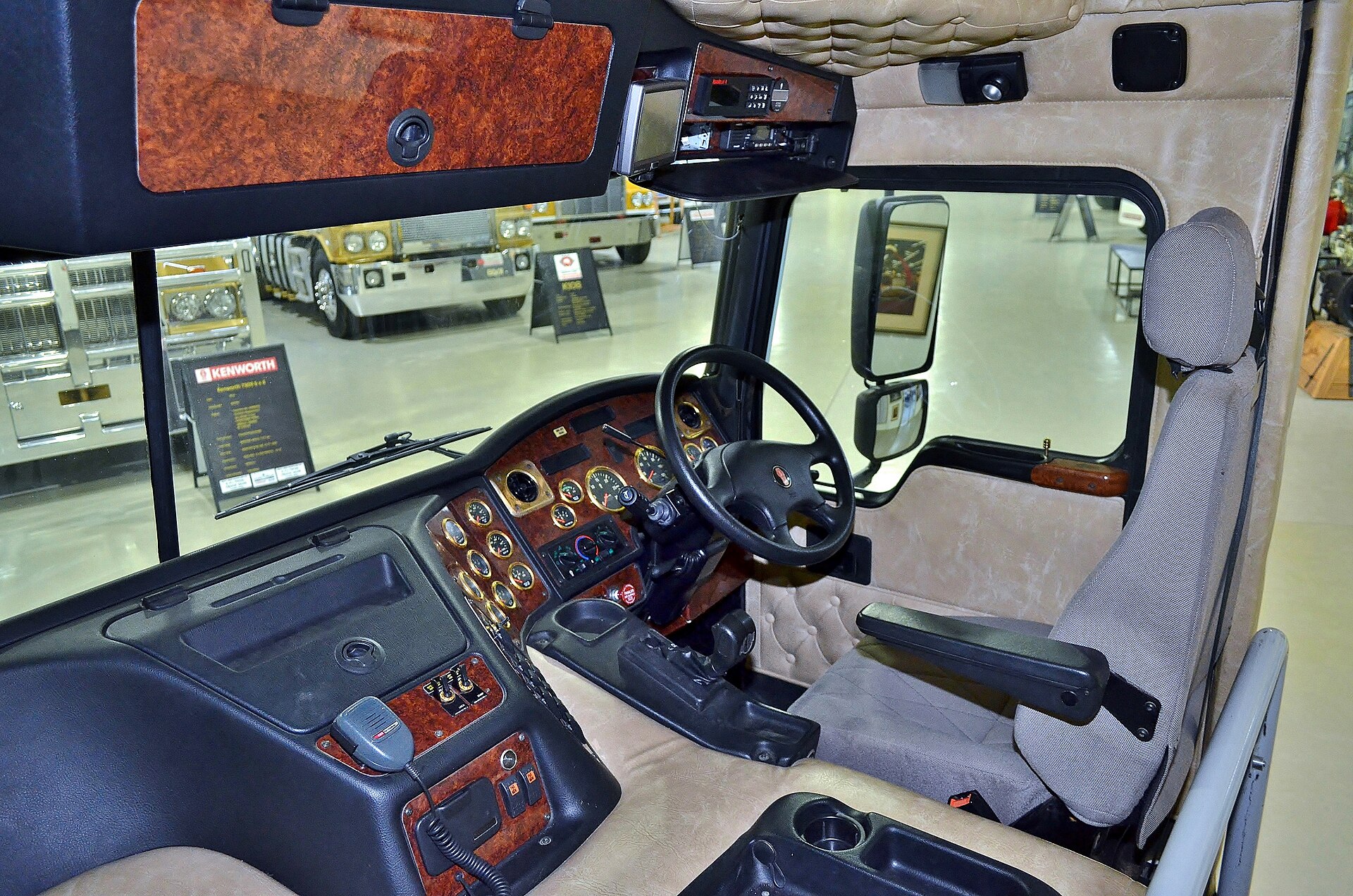 Electronic logging device mounted in commercial truck cab displaying hours of service data