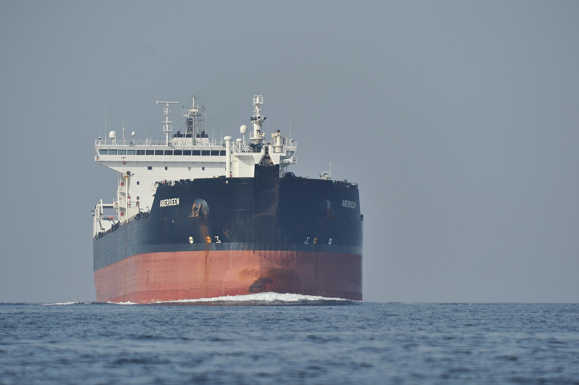 Oil refinery towers against sky as crude prices climb back over one hundred dollars per barrel