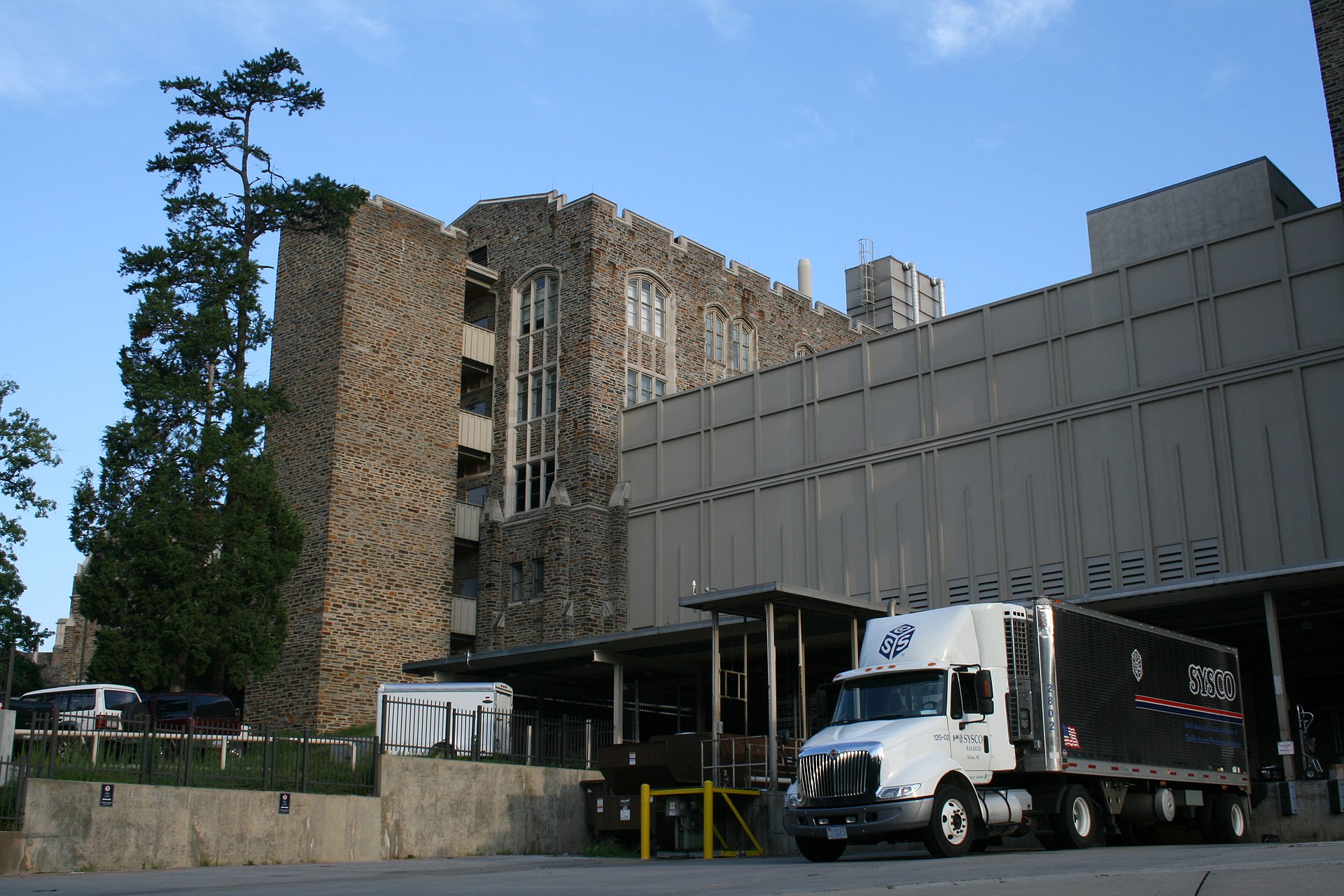 Semi-trailer loaded with produce parked in unsecured lot at dusk
