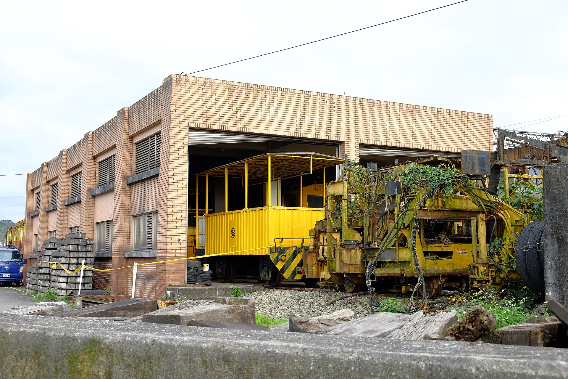 Wabtec locomotive on rail yard tracks with freight cars in background