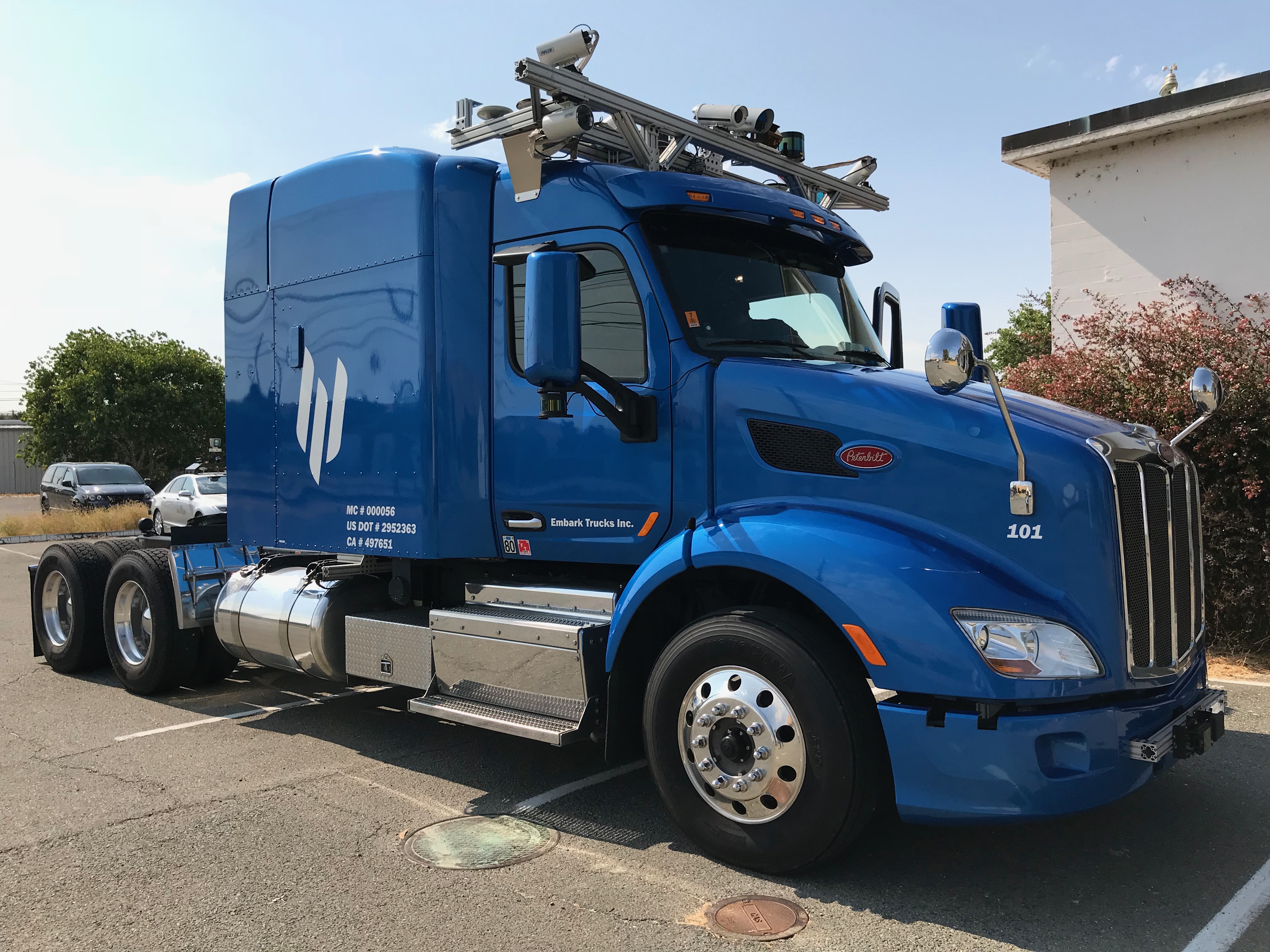 Autonomous Class 8 tractor with lidar and sensor array mounted on cab roof and front bumper