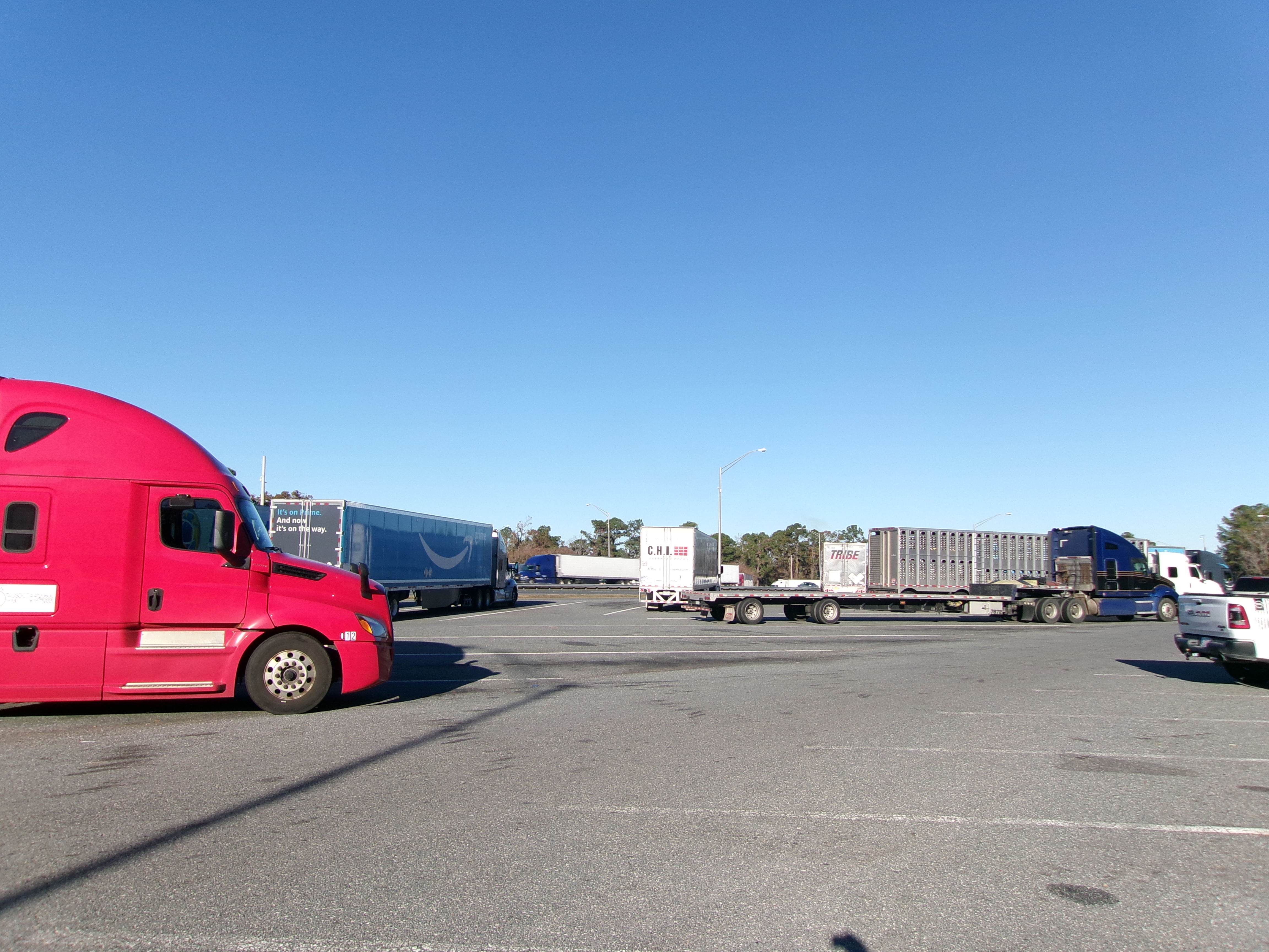Empty truck parking spaces at a highway rest area at dusk