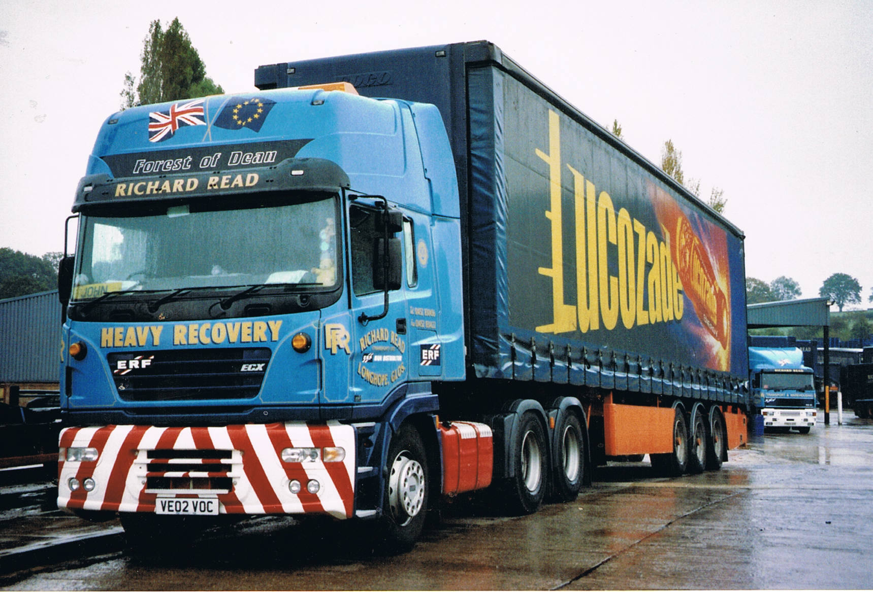 Semi truck parked at a closed trucking terminal with bankruptcy notice on the door