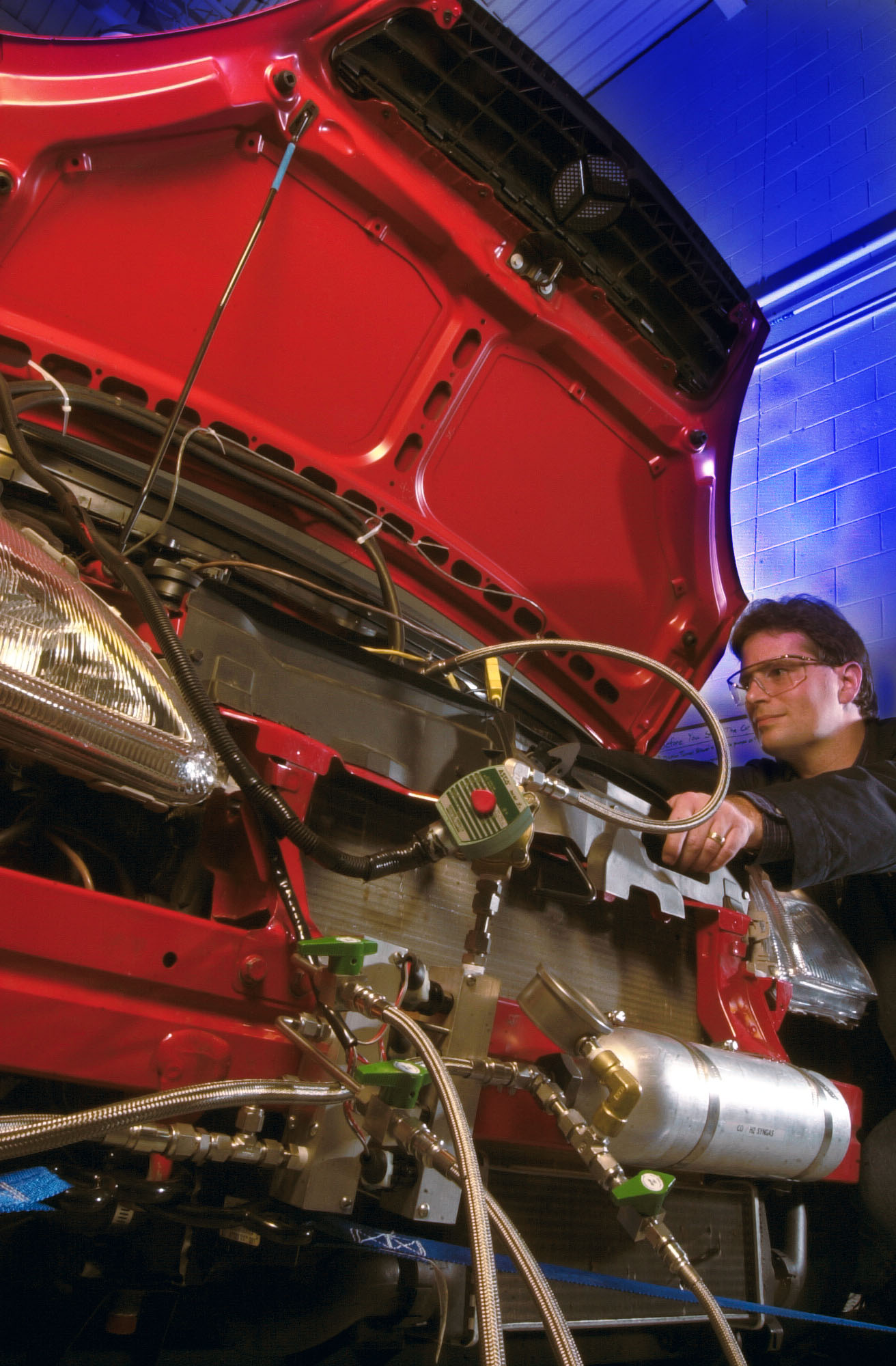 Heavy-duty diesel engine with SCR aftertreatment canister and DEF tank visible under truck frame