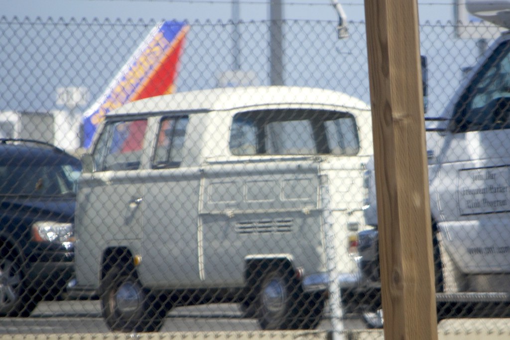 Ryder semi-tractor on dealer lot with used truck inventory in background