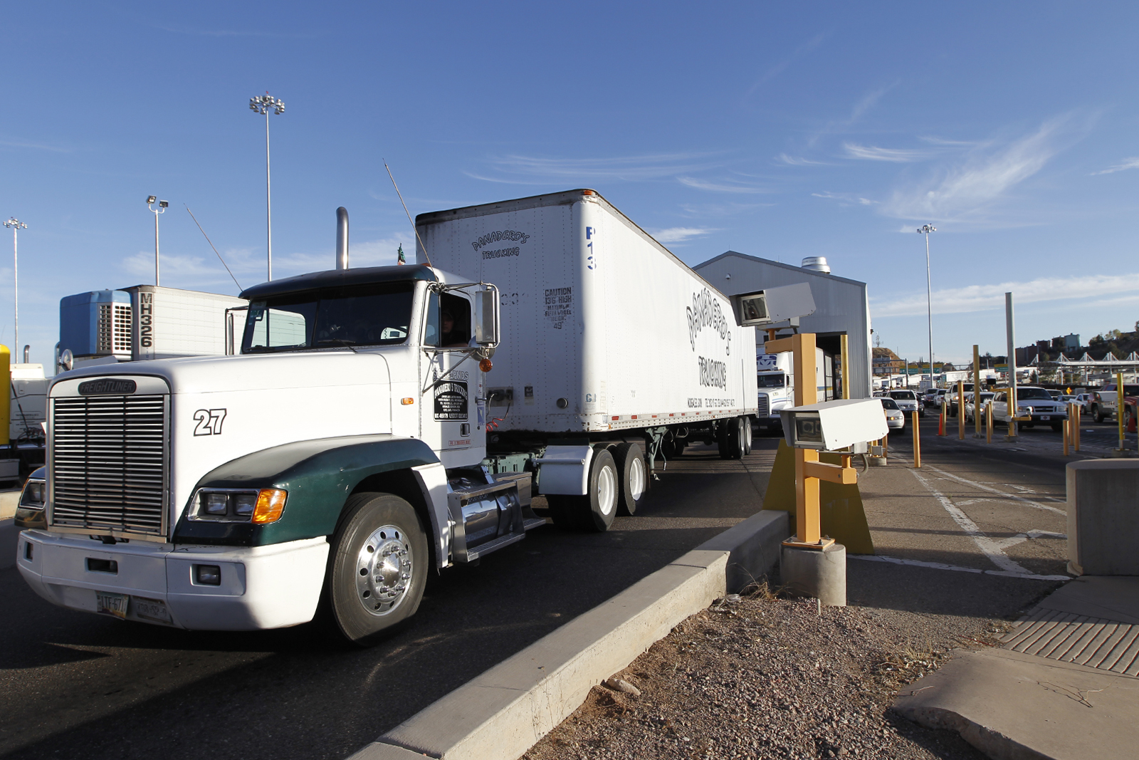 U.S. Customs and Border Protection officers inspect a commercial tractor at a cargo facility on the Texas-Mexico border