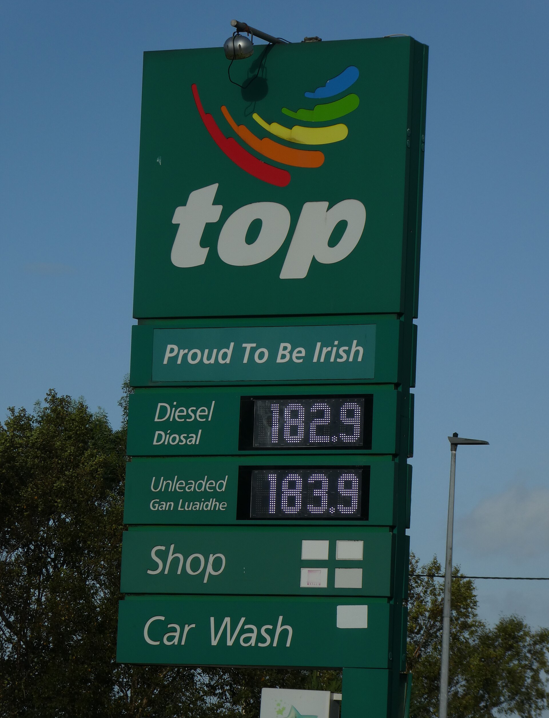 Container ship at port terminal with fuel tanker trucks in foreground