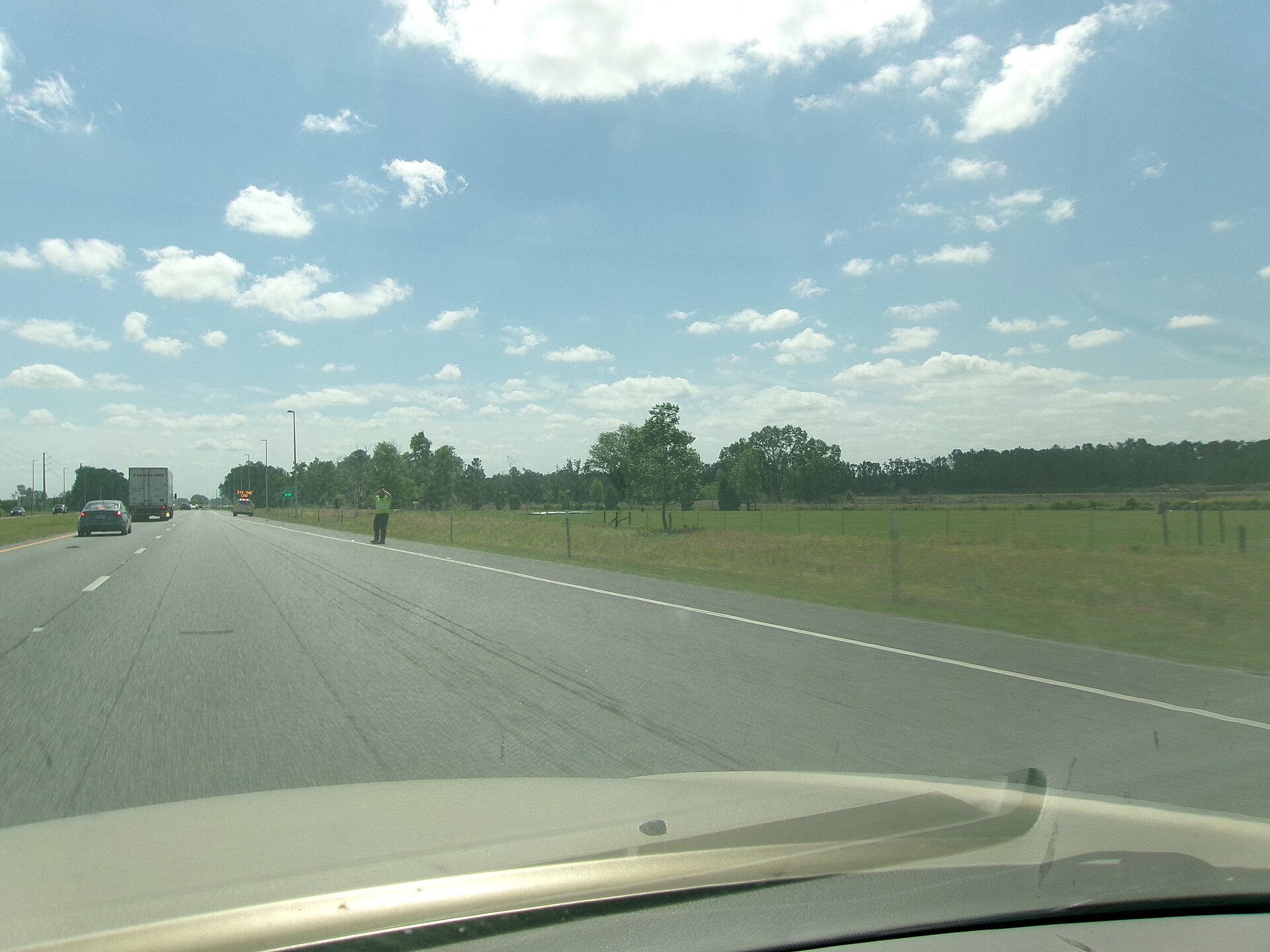Commercial truck approaching weigh station with bypass signage visible on highway