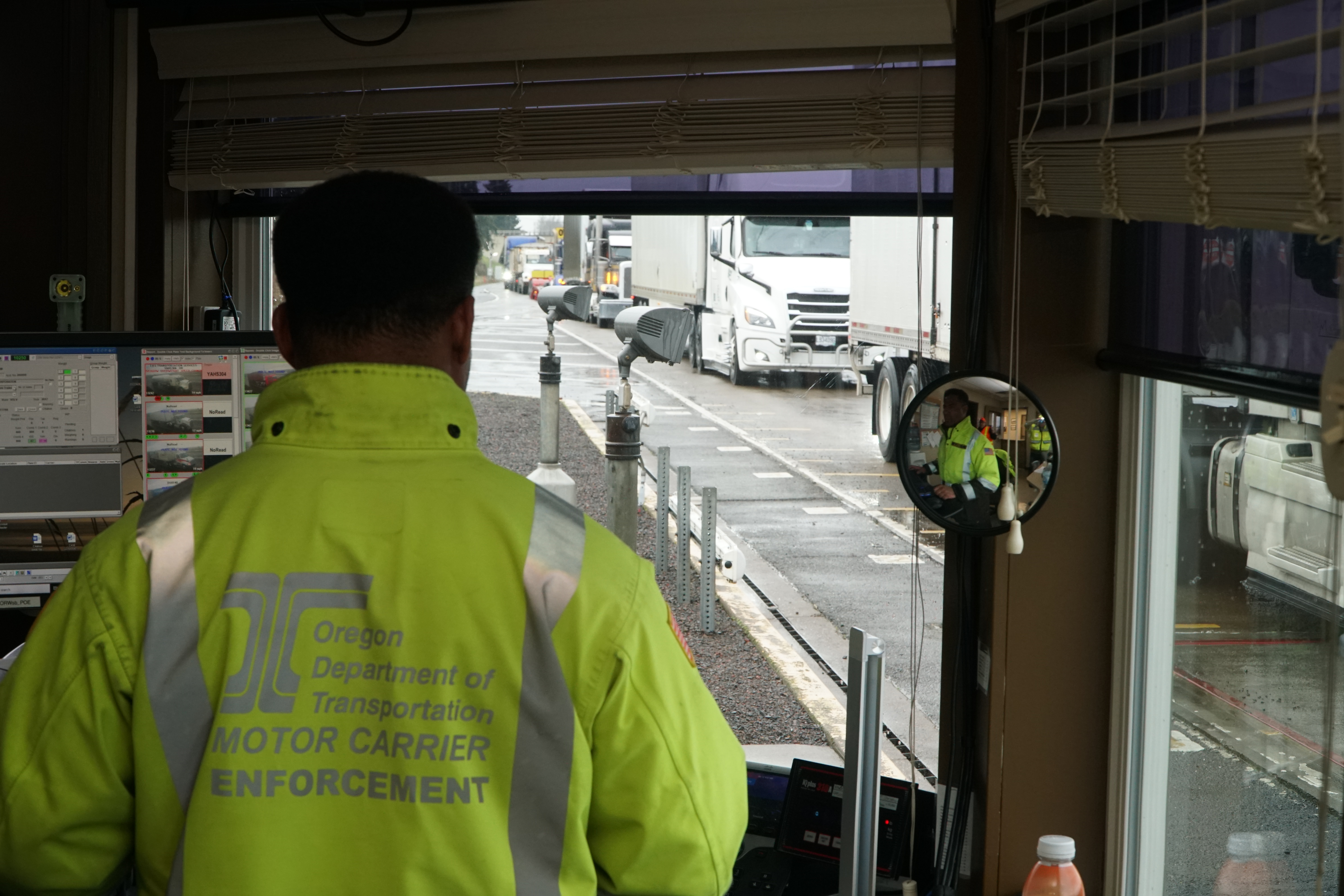 Commercial trucks queued at a U.S.-Mexico border crossing inspection lane