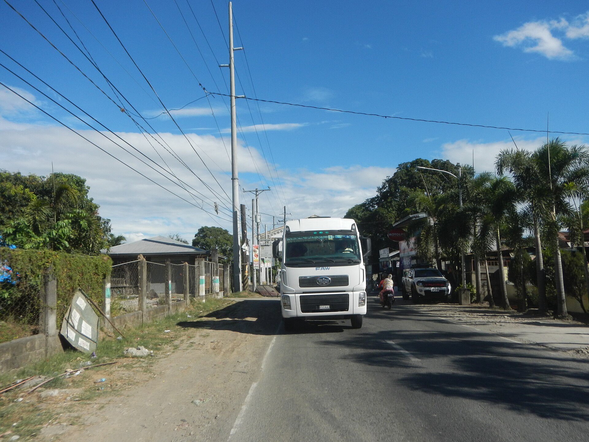 Semi-truck crossing U.S.-Mexico border checkpoint with customs infrastructure visible