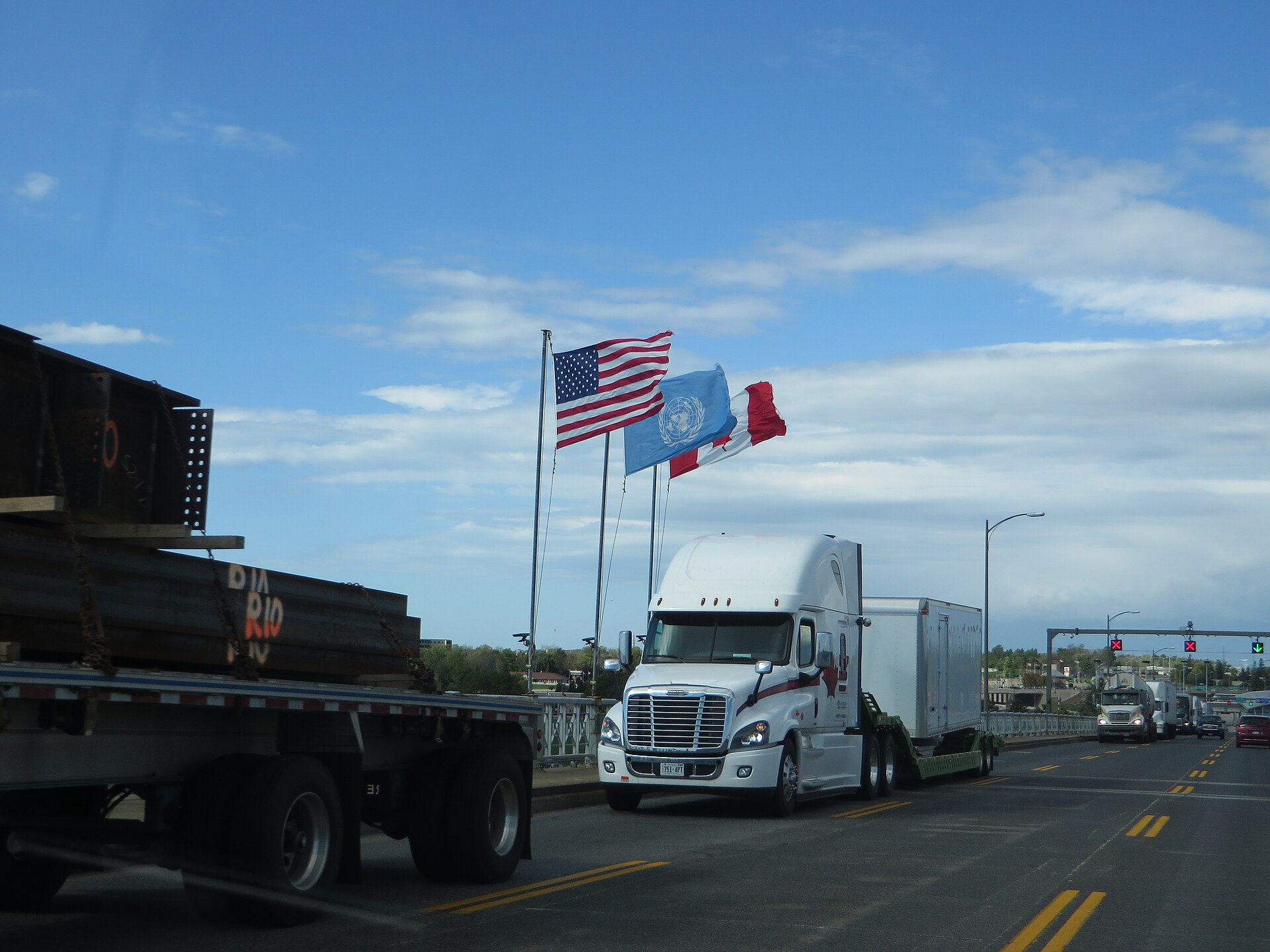 Roadrunner LTL truck on highway carrying cross-border freight between Canada and United States