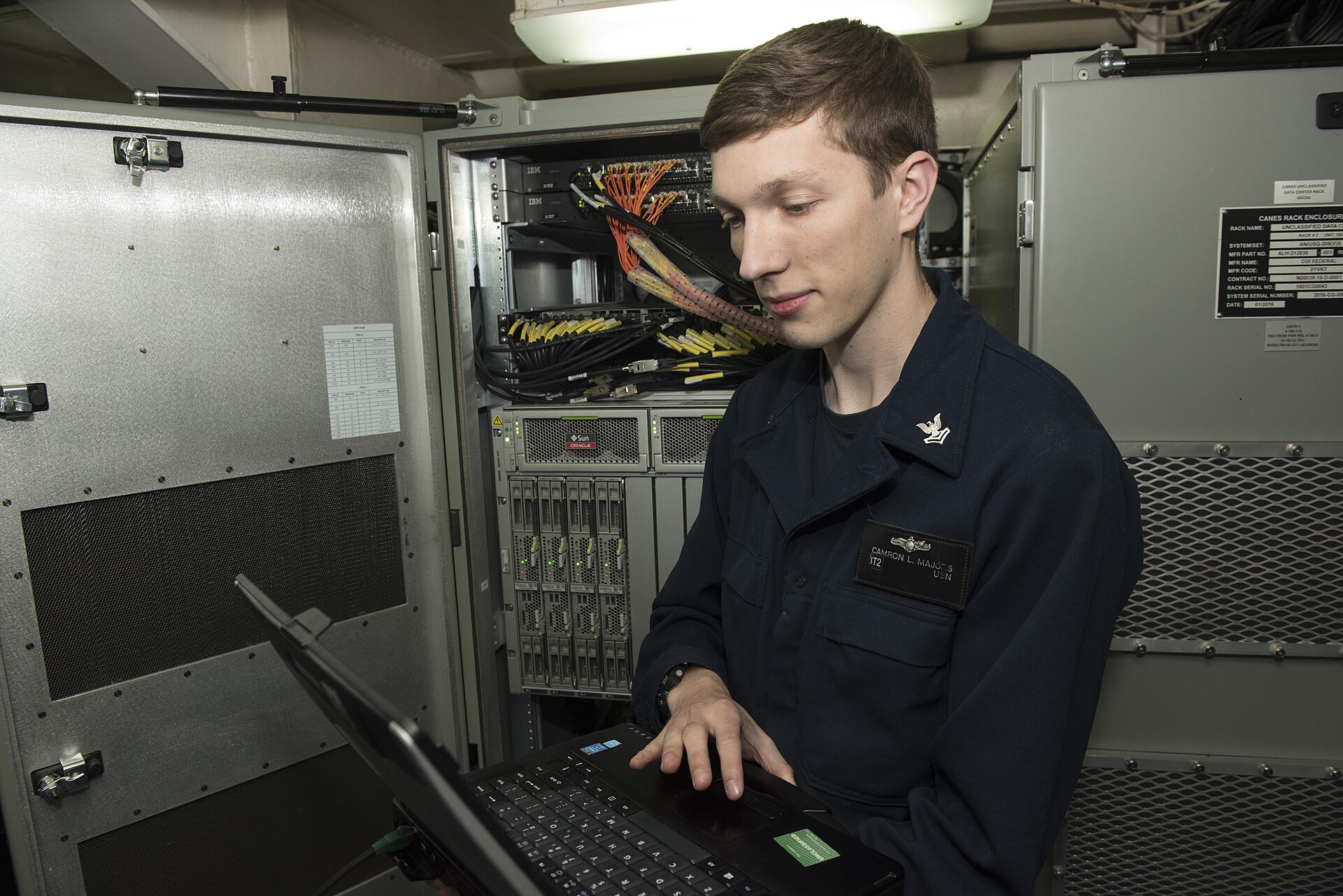 Fleet manager reviewing AI tool usage policy on laptop in trucking office