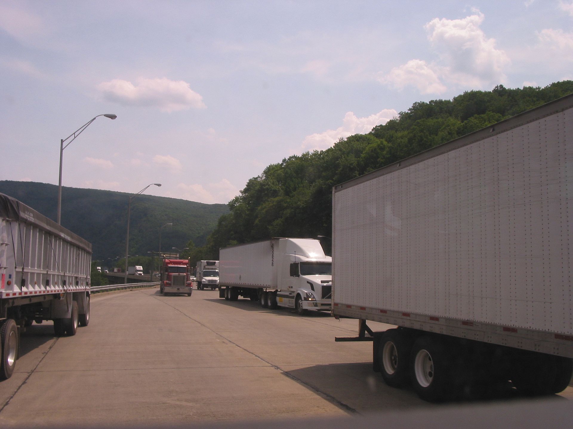 Fleet truck passing through electronic toll gantry on interstate highway