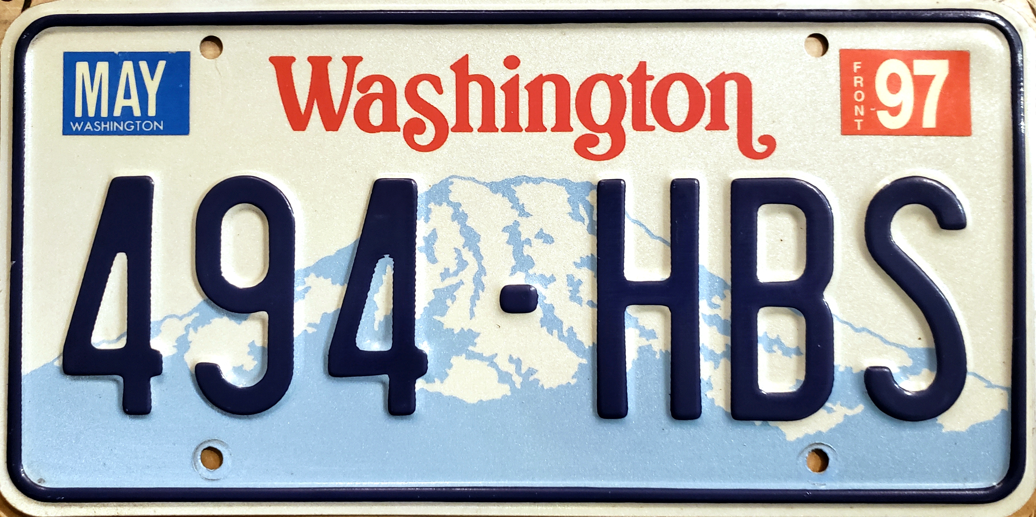Commercial driver's license card on truck dashboard with paperwork