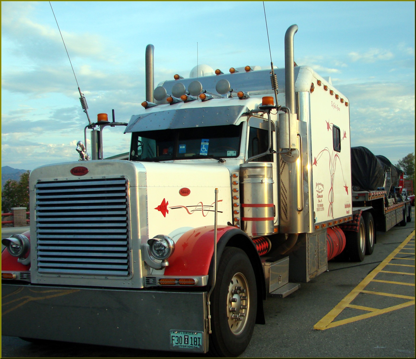 Truck driver reviewing hours-of-service logs in cab with ELD device mounted on dashboard
