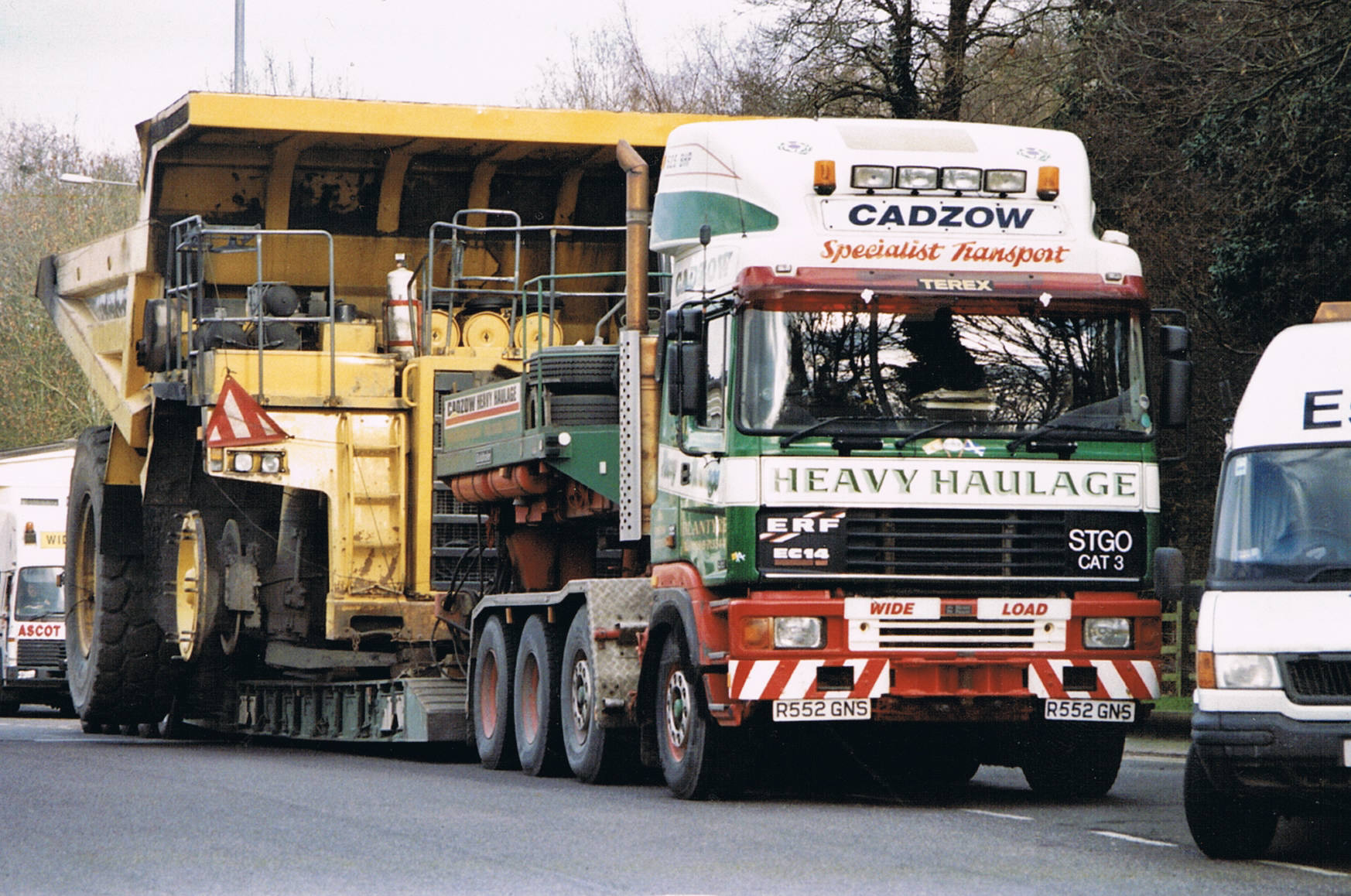 Heavy-haul tractor pulling multi-axle lowboy trailer with oversized construction equipment