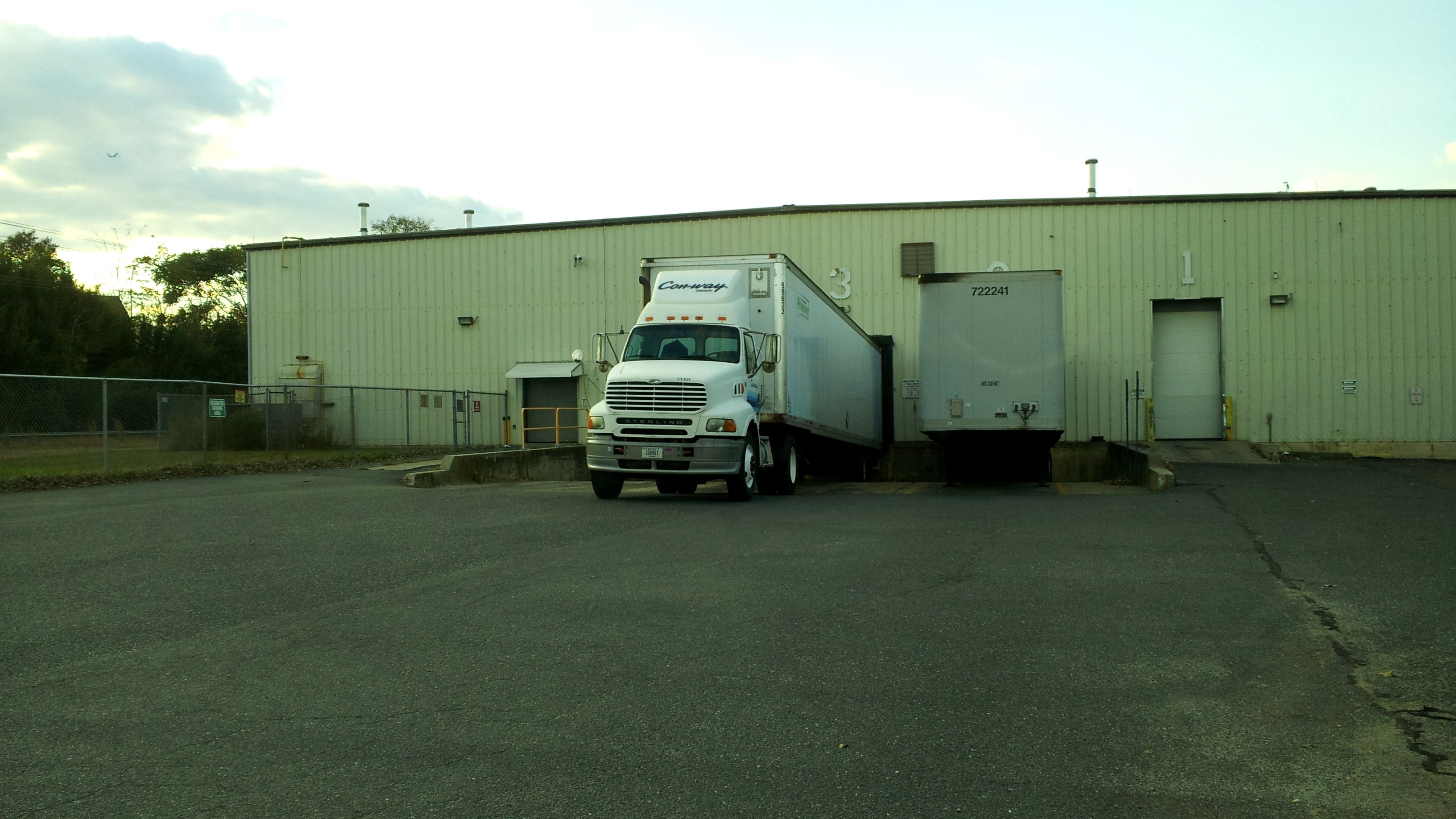 Factory floor with industrial equipment and freight pallets staged for shipment