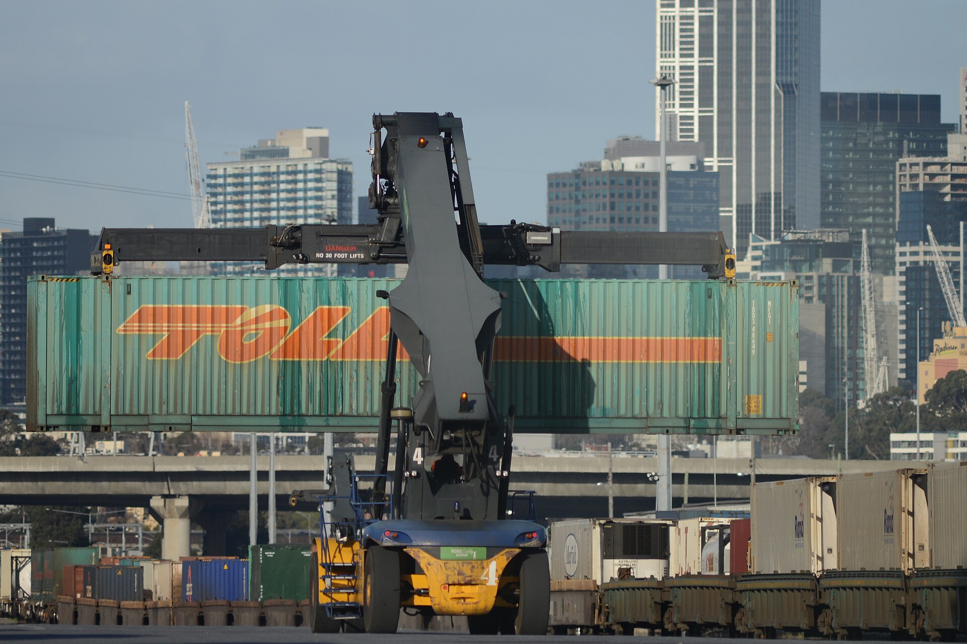 Stacked shipping containers on a rail flatcar at an intermodal terminal