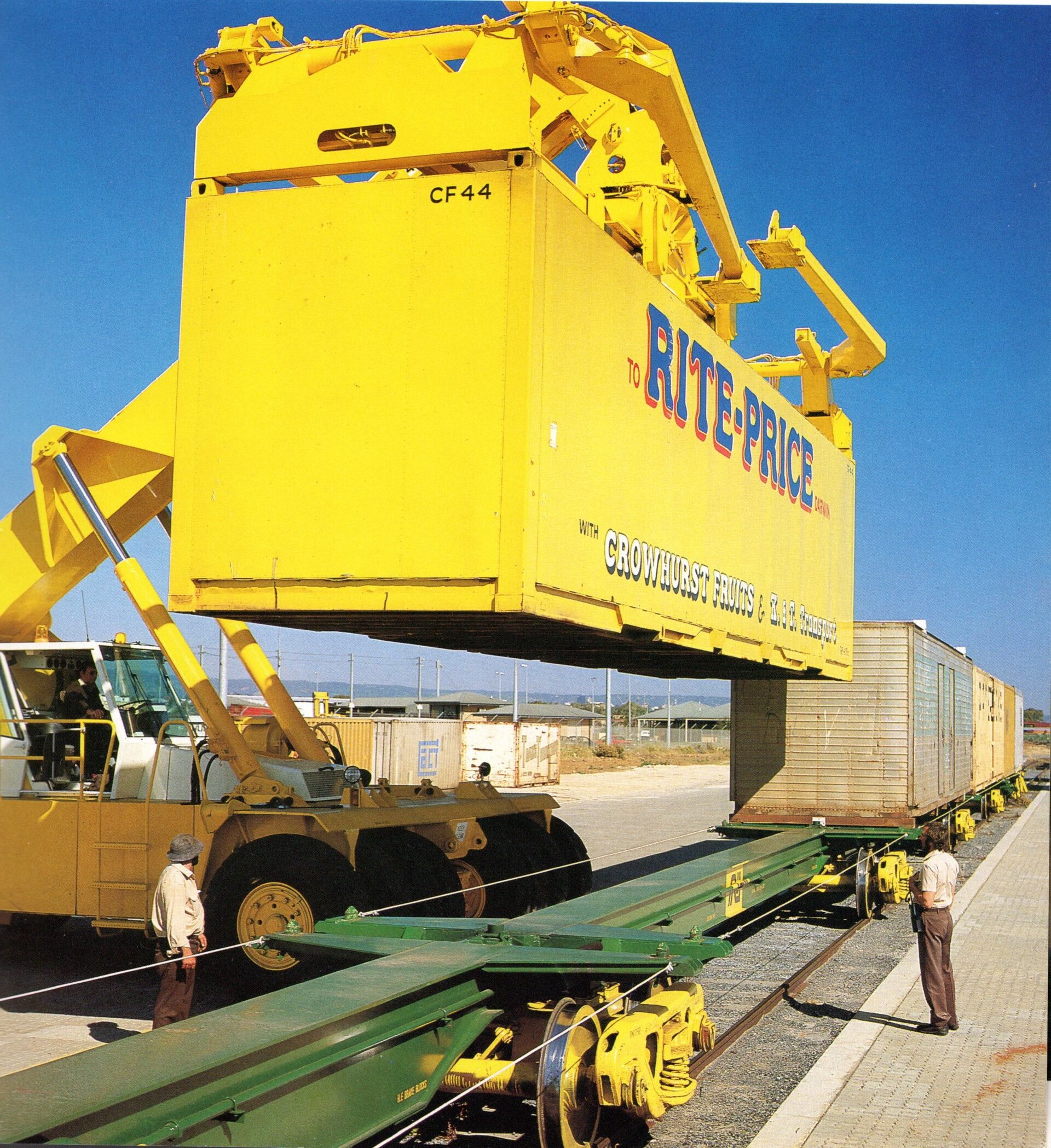 Intermodal container being loaded onto a rail car at a freight terminal