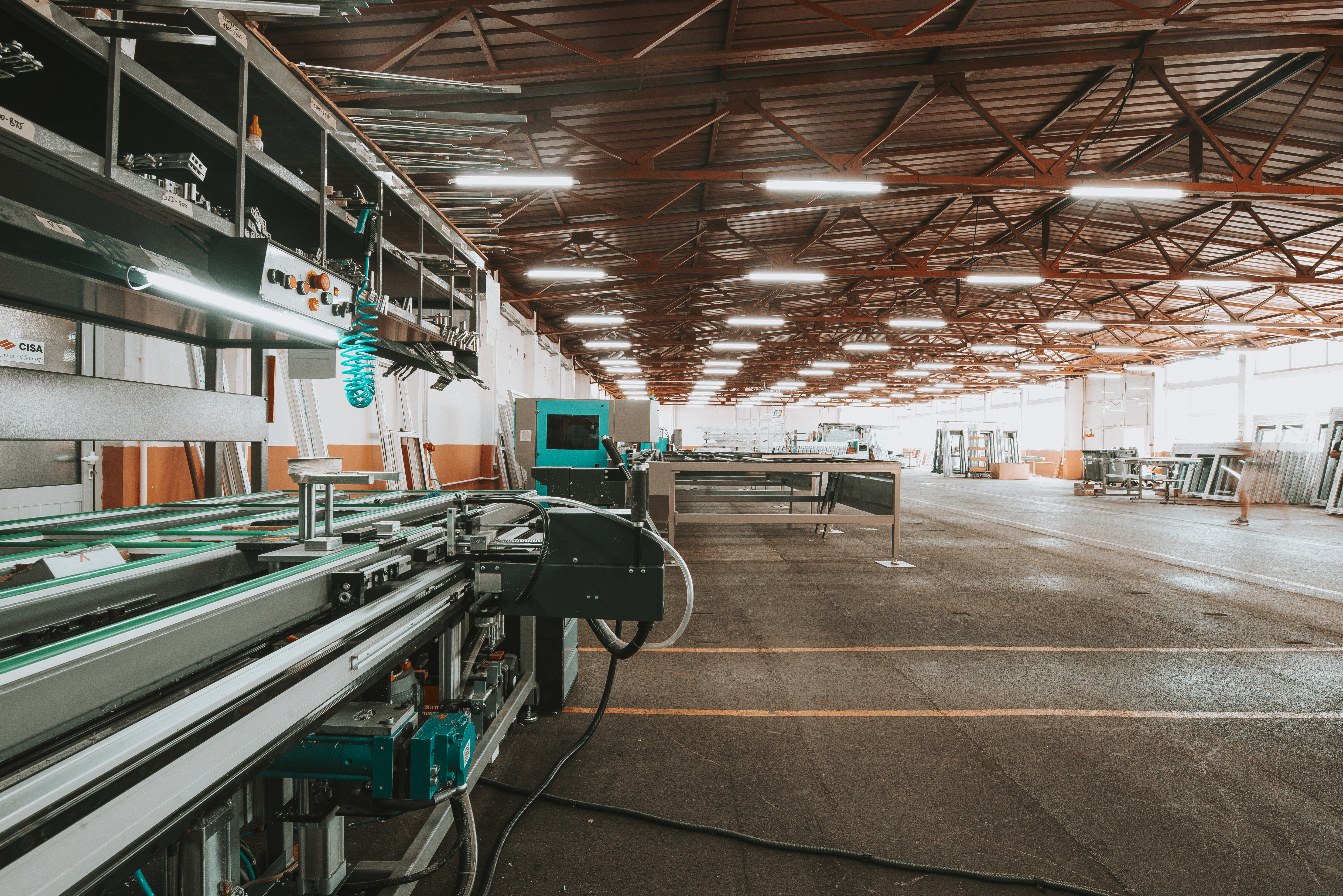 Manufacturing facility floor with workers and machinery in operation