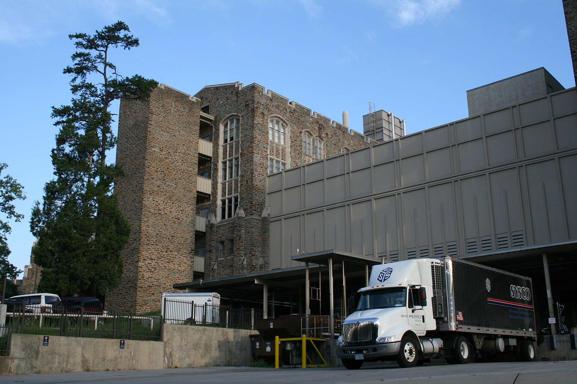 Semi-trailer loaded with produce parked in unsecured lot at dusk