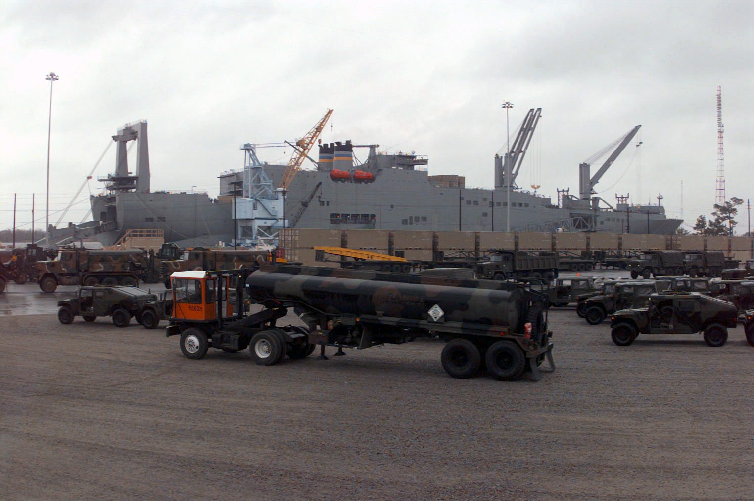 Fuel tanker ship at sea under cloudy sky, representing transoceanic military fuel shipments