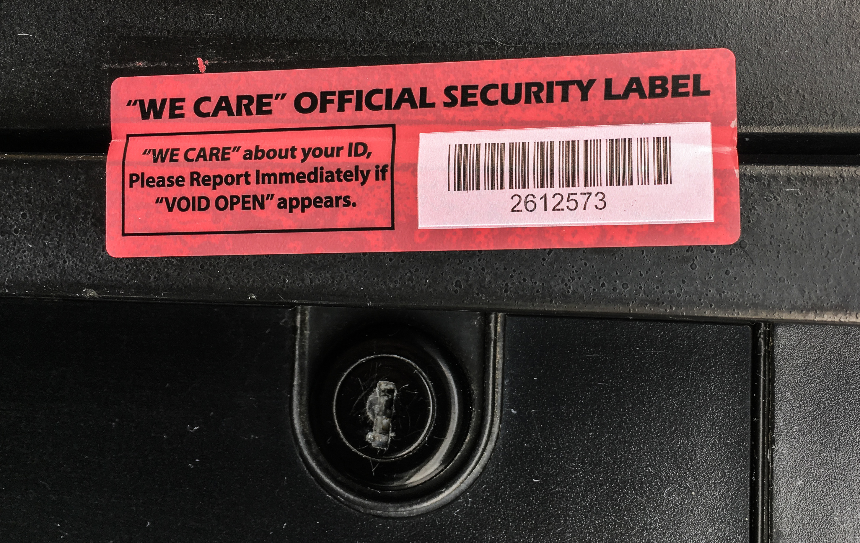 Driver holding smartphone displaying fake traffic ticket text message