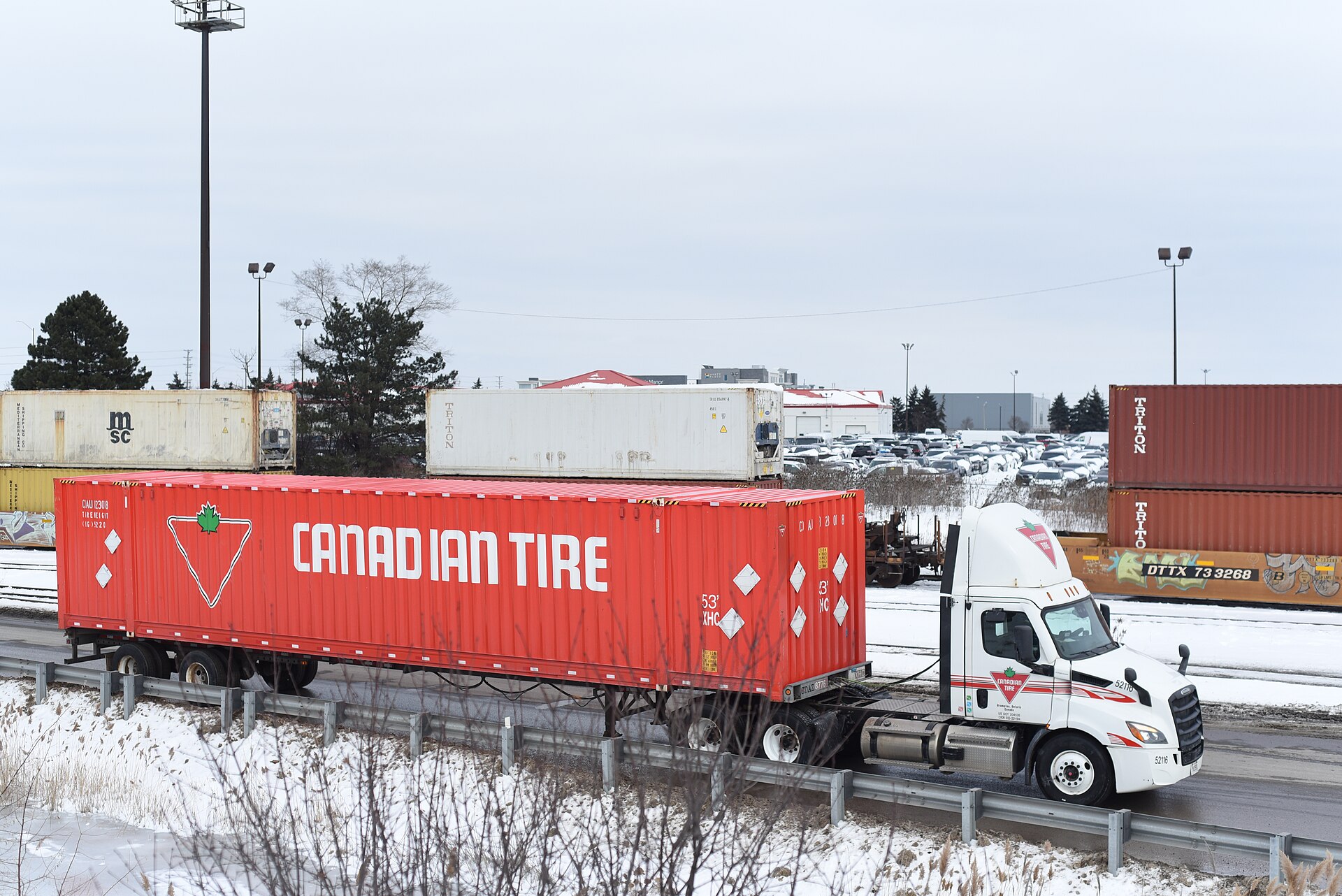 Schneider National semi-truck on highway, representing the carrier's truckload and intermodal operations under new leadership