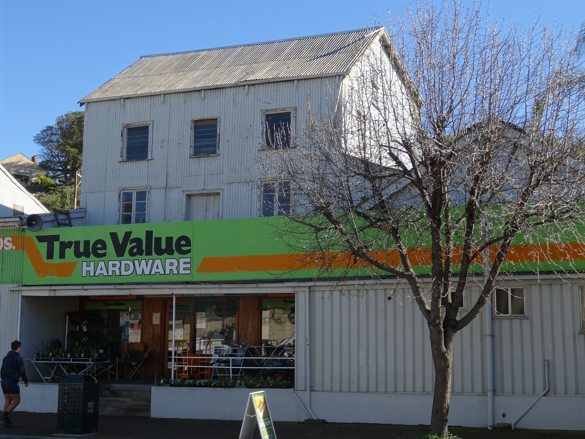 Steel coils stacked in a manufacturing facility, representing raw material used in trailer production