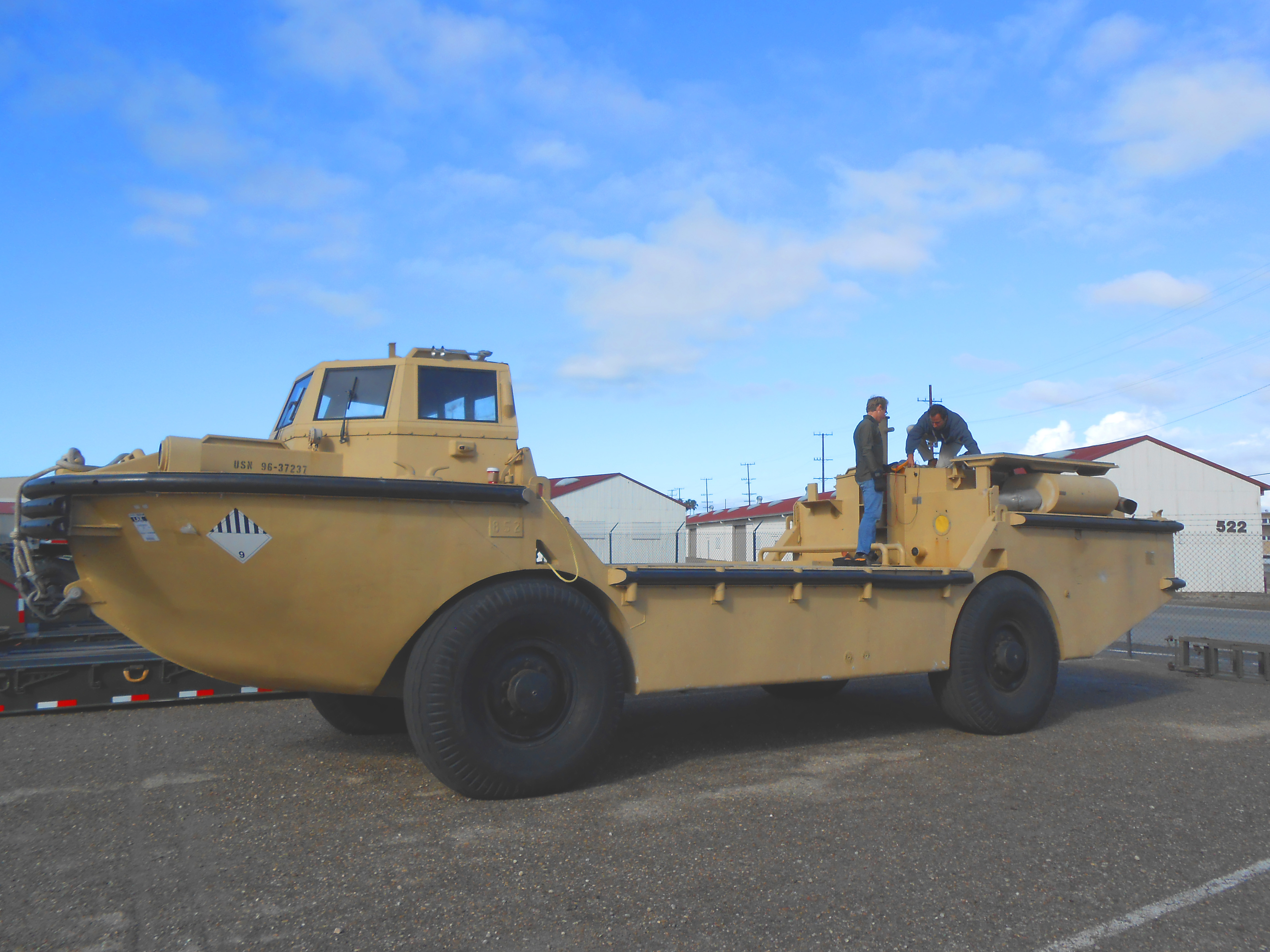 Commercial truck undergoing preventive maintenance inspection in fleet shop bay