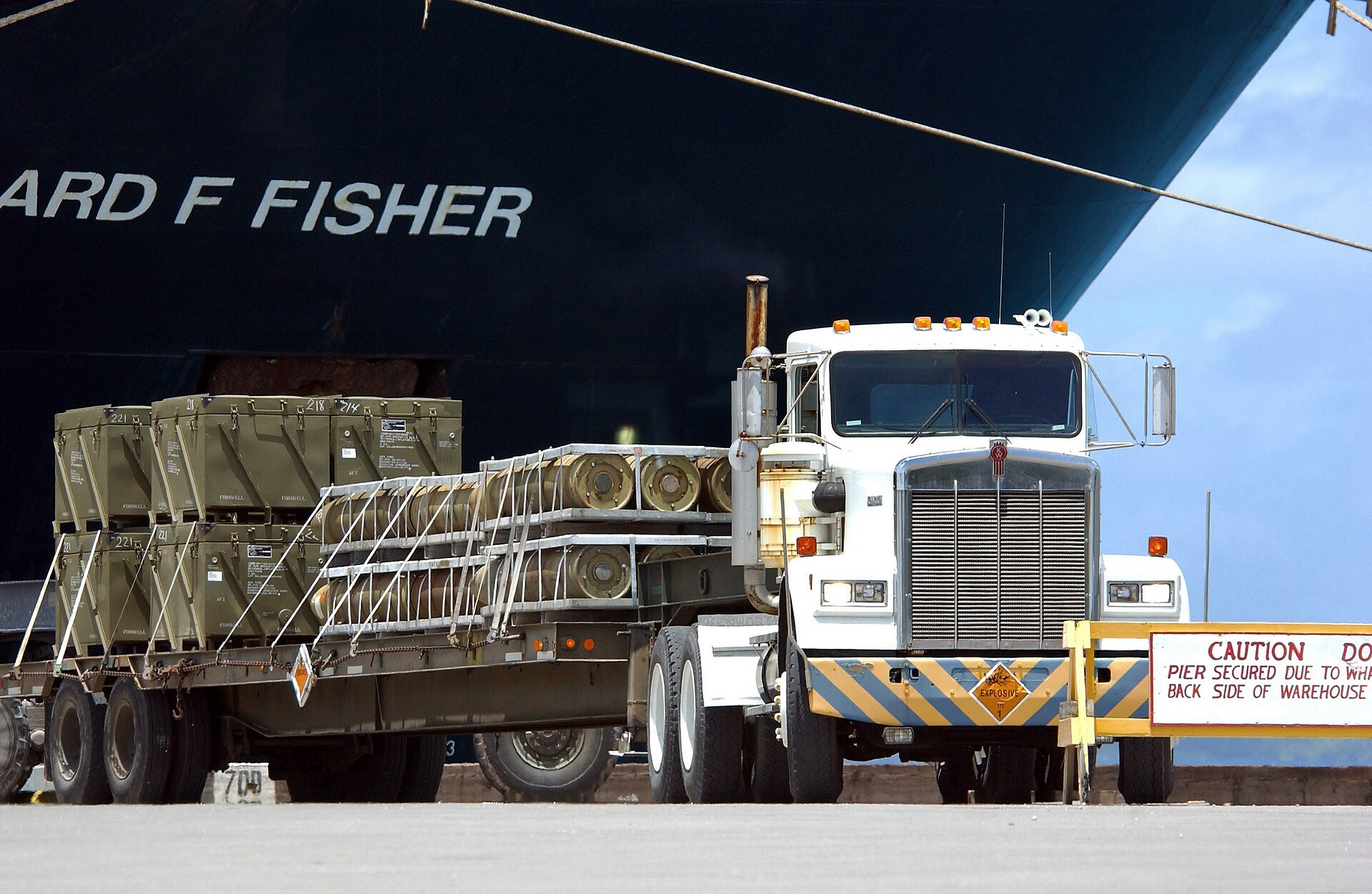 TFI International tractor and flatbed trailer on highway