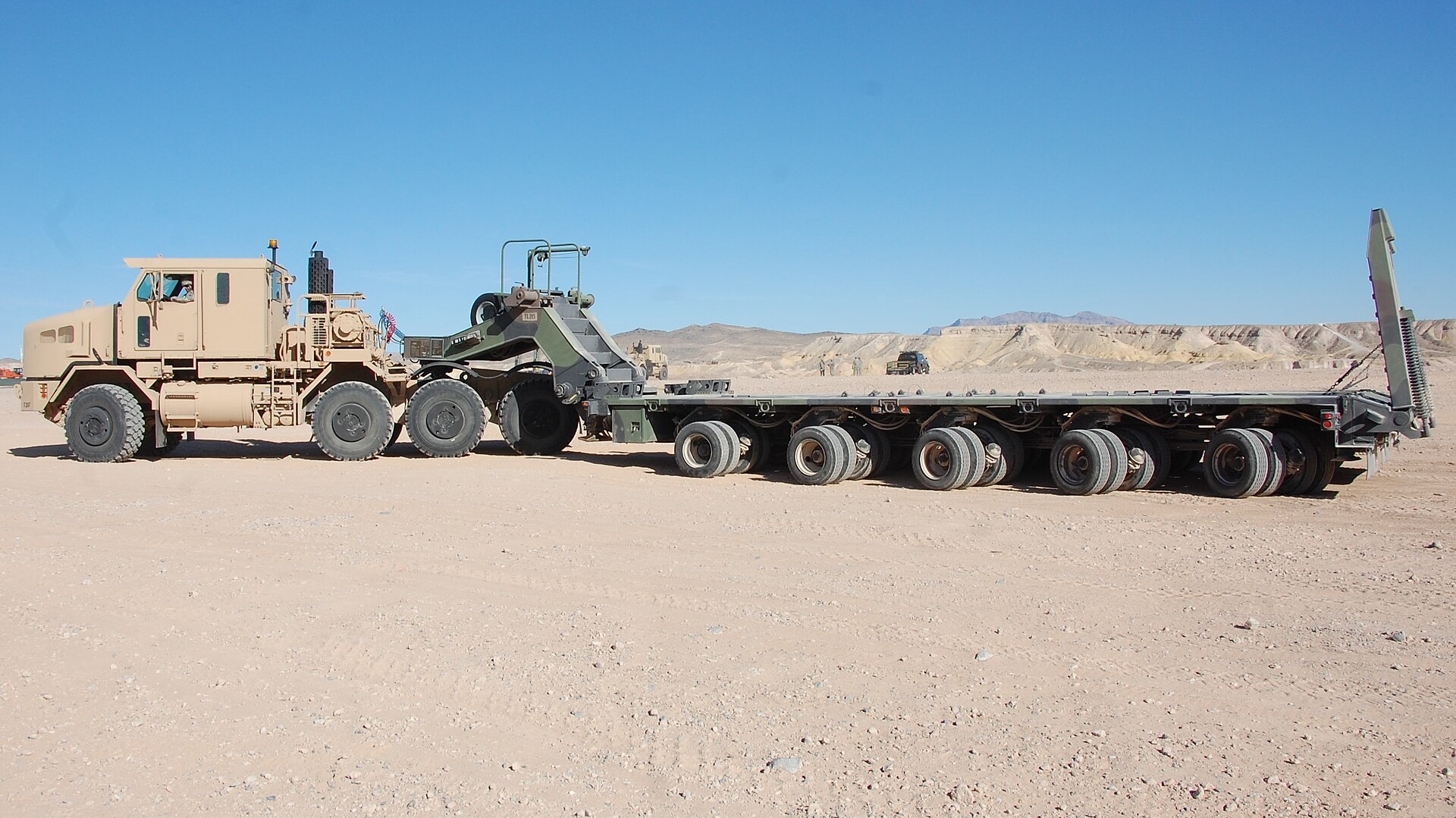 Flatbed trailer loaded with construction materials on highway
