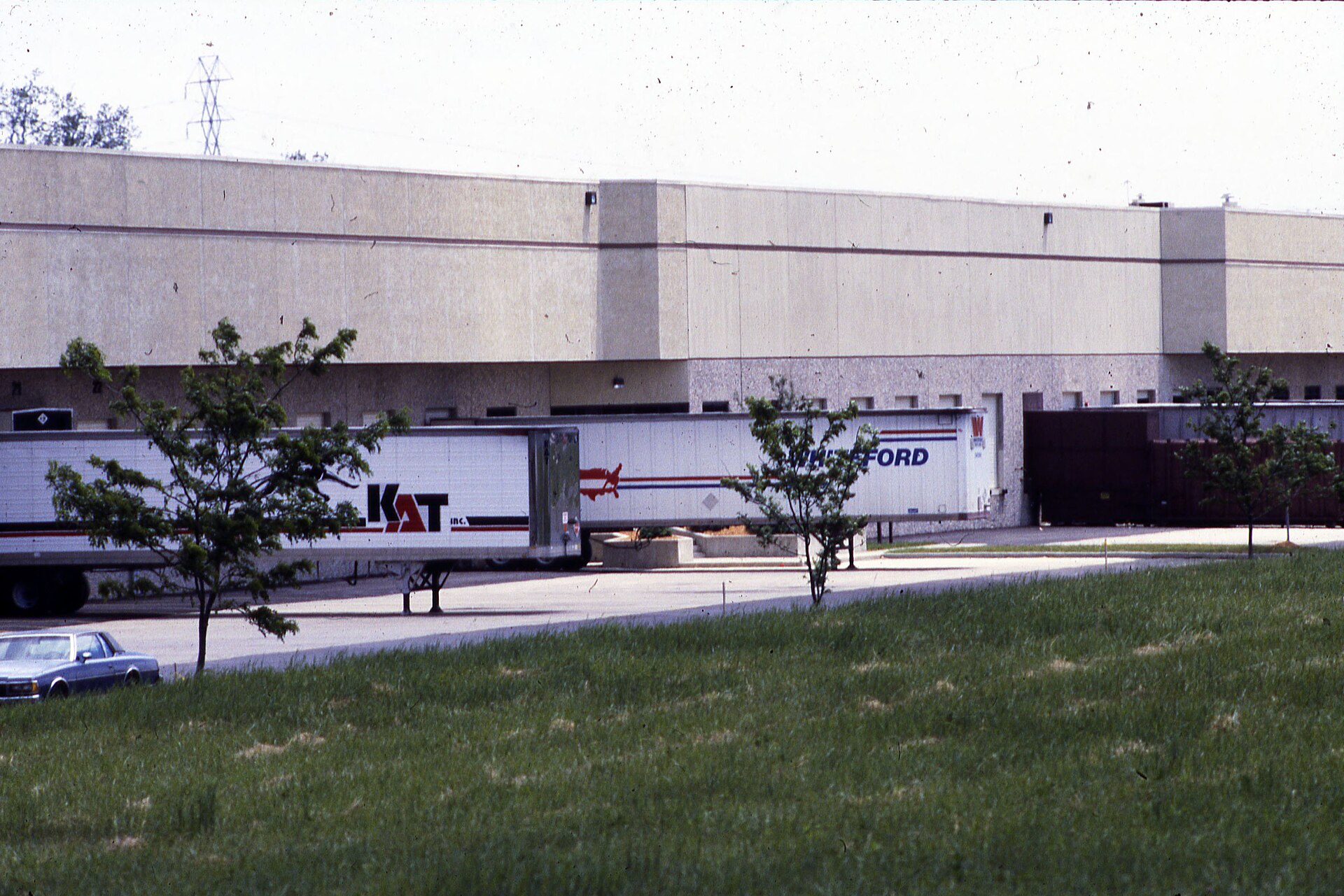 Gate camera system at distribution center recording truck and trailer movements for yard management and cargo security investigation